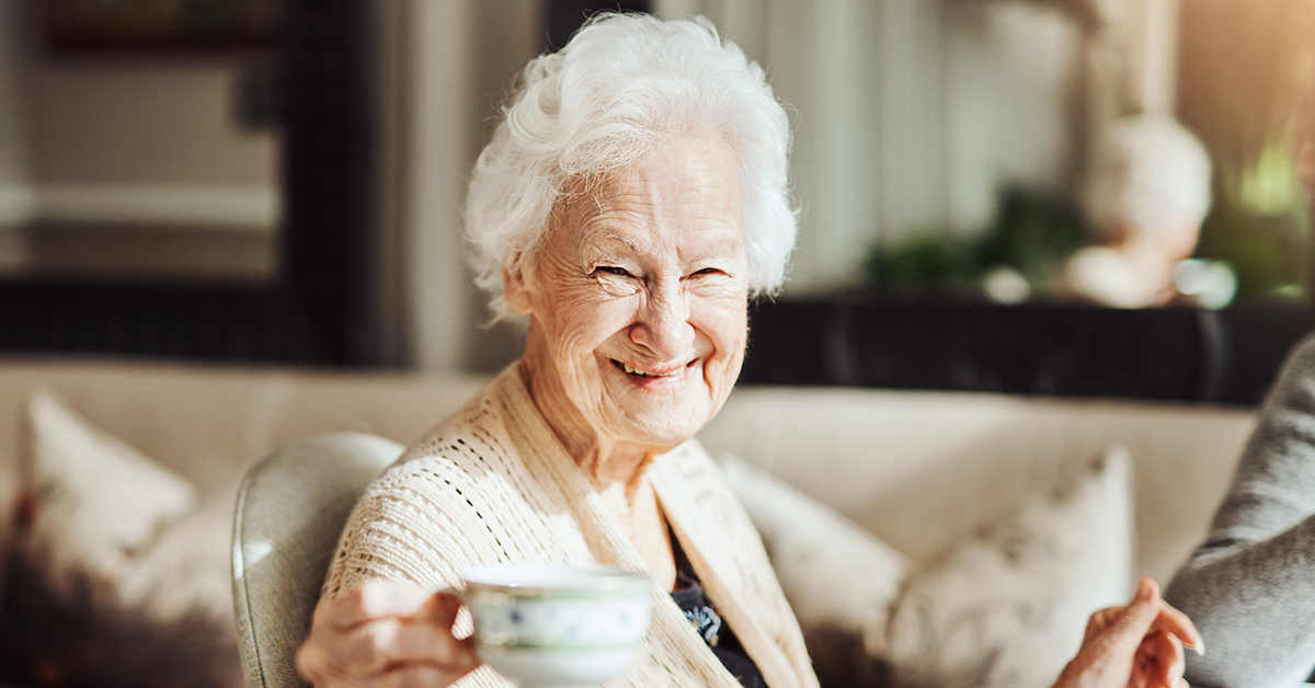 Portrait of happy senior women having tea together at a retirement home